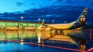 Illustration of Alaska Airlines aircraft grounded due to an IT outage, leaving passengers stranded, created by artificial intelligence.