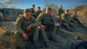 Illustration of Russian soldiers near the Ukrainian border experiencing declining civilian support and morale challenges.