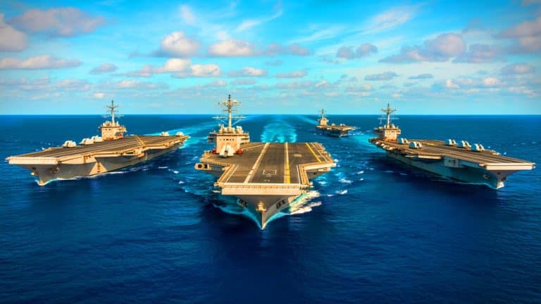 Caribbean Buildup Sparks Strategic Shifts Amid Carrier Aircraft Loss, China’s AI Ambitions, and Court’s Guard Decision Reversal