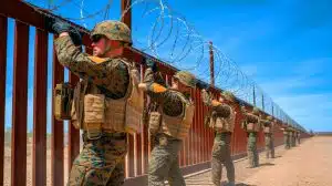 Illustration of U.S. Marines reinforcing the southern border barrier in Yuma, Arizona.